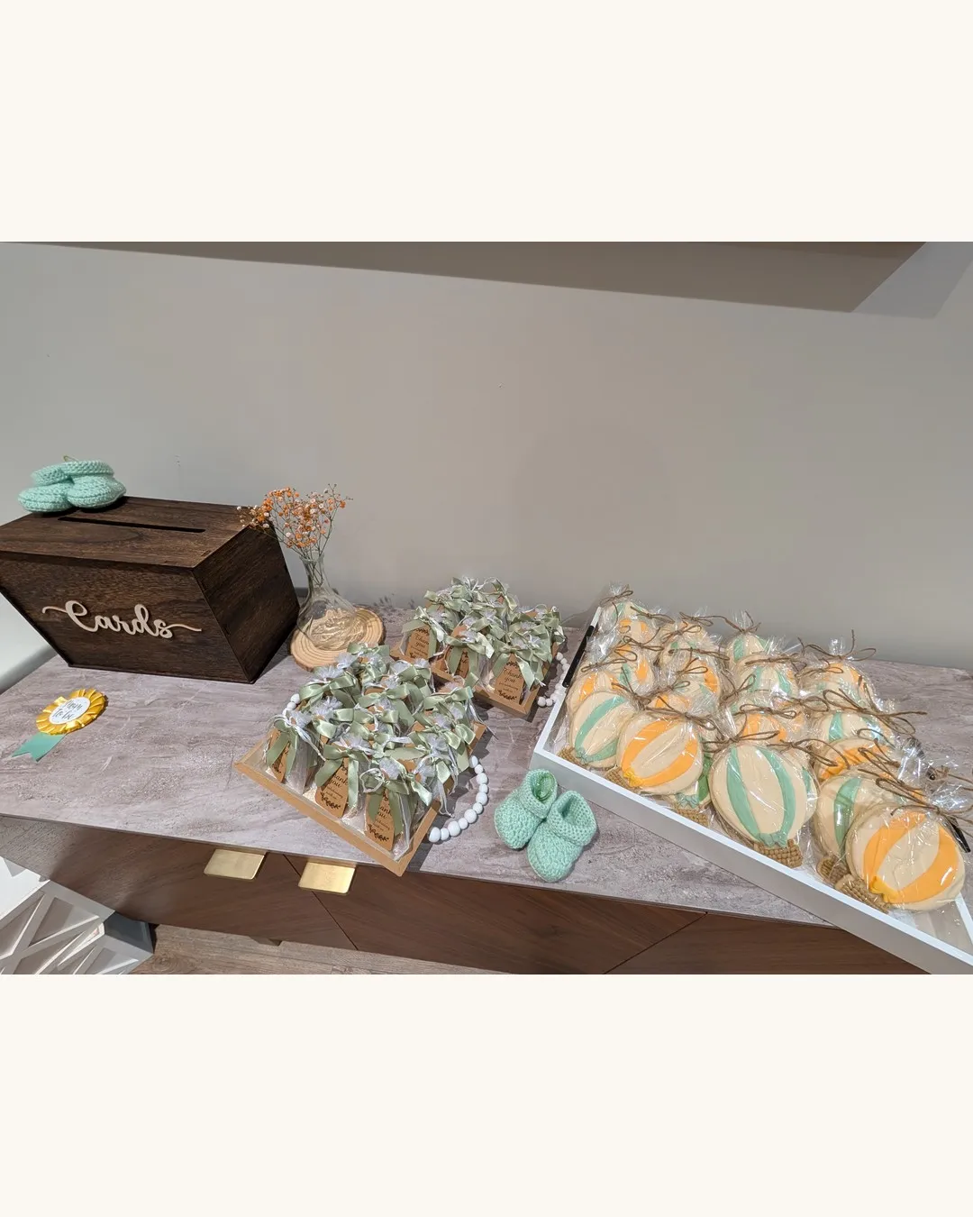 Dessert and favour table with a wooden card box, cookies and small succulents